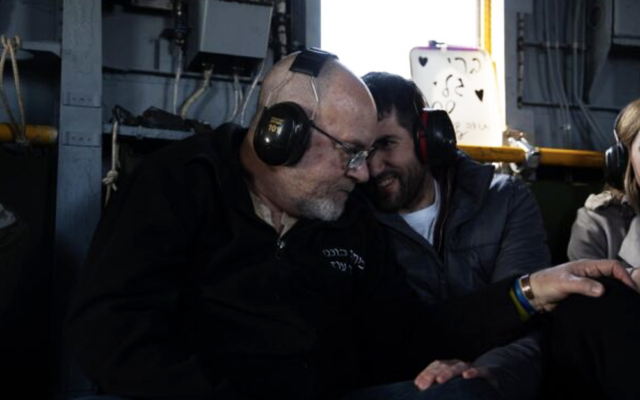 Freed hostage Sagui Dekel-Chen (right) with his father Jonathan aboard an IDF helicopter en route to the hospital soon after his release from 498 days in Hamas captivity in Gaza, February 15, 2025. (IDF)